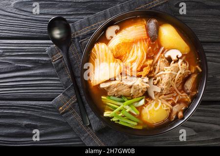 Korean Gamjatang is a spicy hearty stew made with pork bones close up in the bowl on the table. Horizontal top view from above Stock Photo