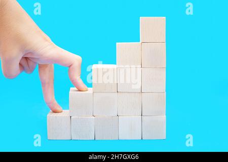 Steps made with wooden blocks on table against grey background, space ...