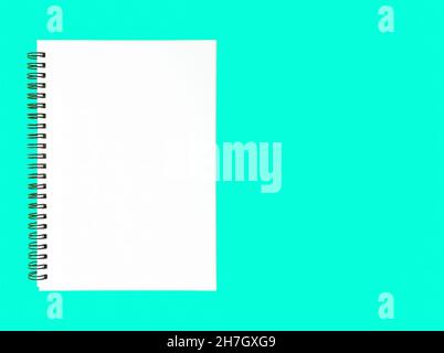 Blank wire bound notebook on a blue background Stock Photo