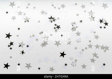 Confetti black silver and white stars on a white background. Top view Stock Photo