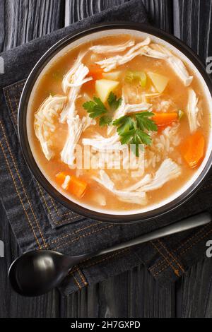 Canja de galinha recipe is a classic chicken and rice soup close up in the plate on the table. Vertical top view from above Stock Photo
