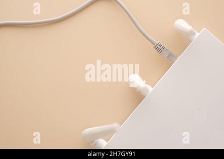 Wi-Fi router with cables on table  Stock Photo