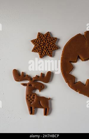 Beautiful deer carved on raw ginger dough Concept of Preparation for Christmas and New Year. Home baked gingerbread, close-up, selective focus Stock Photo