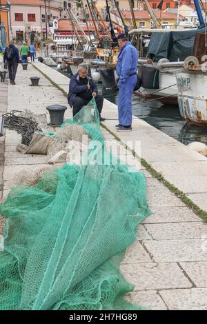 Fishermen repairing  the fishing net,Novigrad, Istria, Croatia, Europe. Stock Photo