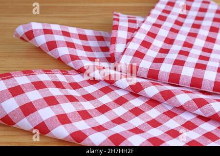 Red and white checkers kitchen towel on wooden table Stock Photo
