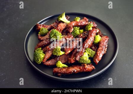 Beef stir-fry with broccoli on plate, close up view Stock Photo