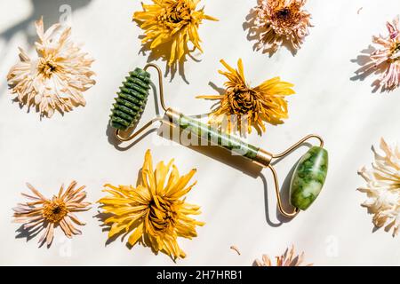 Green jade massager roller for the face on a white background. Stock Photo