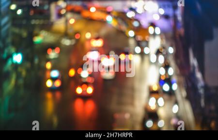 Multicolored bokeh of cars at rush hour in New York city urban area - Defocused traffic jam in highway intersection - Transport concept Stock Photo