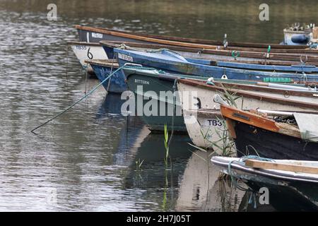 Dinghies moored up on the edge of Ormesby Little Broad, in winter on The Norfolk Broads. Stock Photo