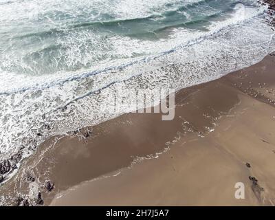 aerial view of waves breaking on shore Stock Photo