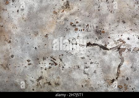 Metal rough texture covered with old weathered swollen beige paint with rust spots, scratches and cracks. Stock Photo