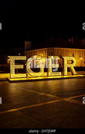 illuminated sign Egger in center of historic city, Northern Hungary Stock Photo