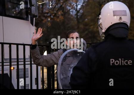Brussels, Belgium. 21st Nov, 2021. A man raises his hands in front of the police as clashes erupt during a demonstration against Covid-19 measures and mandatory Covid safe ticket in Brussels, Belgium, November 21, 2021. (Credit Image: © Valeria Mongelli/ZUMA Press Wire) Stock Photo