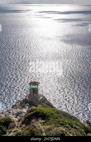 Watchtower on the island of Gorgona, with the island of Capraia in the background, Livorno, Italy Stock Photo