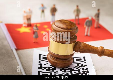 Judge gavel, flag, barcode sheet and plastic toy men, the concept of administrative punishment in China for violation of the QR code regime Stock Photo
