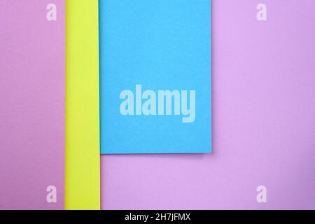 background with geometric shapes. Abstract background from sheets of blue, pink and yellow paper. Thick paper of different colors top view. Abstract p Stock Photo