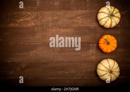 Fall top view background composition. Pumpkins on rustic wooden table. Happy Thanksgiving concept. Fall concept. Flat lay, top view, copy space Stock Photo
