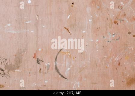 Colorful paint splashes on wooden board. Flat lay, top view. Abstract background from a painter workshop. White, brown and grey colors on plywood Stock Photo