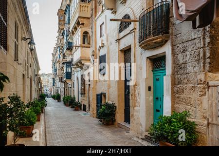 Traditional colorful Maltese doors in Valletta. Front doors to houses from Malta. Blue green doors and wooden balcony. Maltese vintage apartment build Stock Photo
