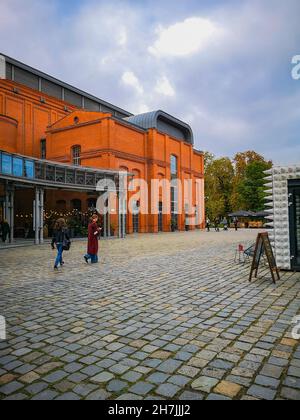 Poznan, Poland - October 2 2020: Outdoor square of Old Brewery shopping mall with facade of red brick building Stock Photo