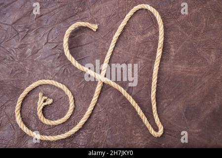 Capital letter A written with jute rope, on textured natural leather Stock Photo