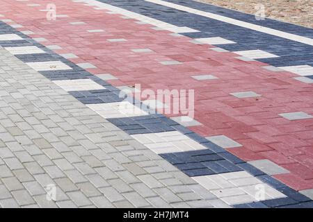 new modern colorful paved walkway and bicycle lane with cobblestones of different colors Stock Photo