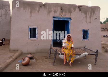 A woman smoking cigarette, in a village, in Omerkot, Sindh province, Pakistan. April 27, 2005. Stock Photo