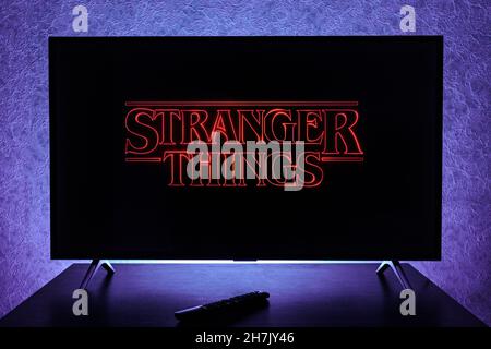 Watching Stranger Things television show on TV. Stranger Things is an American science fiction horror drama television series created by the Duffer Br Stock Photo