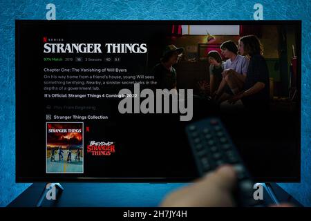 Watching Stranger Things television show on TV. Stranger Things is an American science fiction horror drama television series created by the Duffer Br Stock Photo