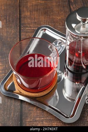 Hot winter tea served with a french press on a wooden floor Stock Photo