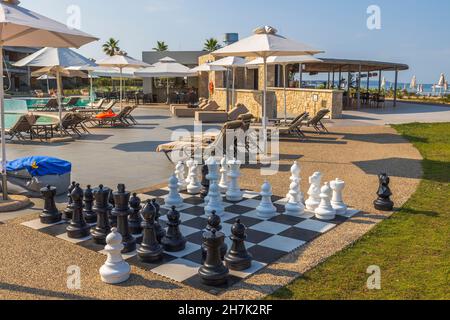 Beautiful view of big chess figures for outdoor activities near swimming pool and bär. Greece. Nea Potidaea. Stock Photo