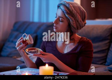 Soothsayer telling her fortune by using the tasseography method Stock Photo