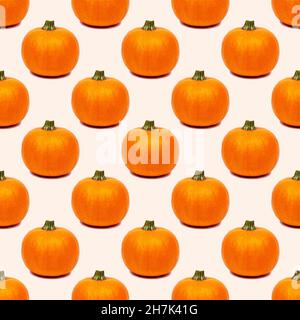 Yellow and orange pumpkin repeat seamless pattern on light background. Stock Photo