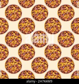 Top view of brown raisins (dried yellow grape) in round wooden bowl repeat seamless pattern on light background. Stock Photo