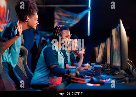 Professional gamers involved in team play in cyber club Stock Photo