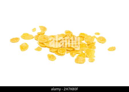 Golden yellow crunchy corn flakes cereal heap isolated on white background. Stock Photo