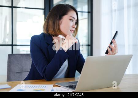 Portrait of beautiful and smart young entrepreneur businesswoman working in modern work station. Stock Photo