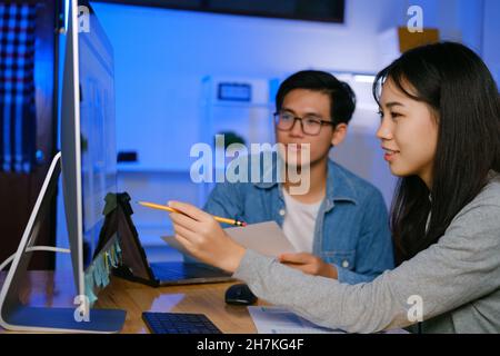 Programmer and developer teamwork working in a software development and coding technologies at night. Stock Photo