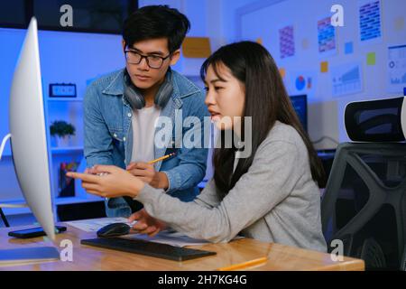 Programmer and developer teamwork working in a software development and coding technologies at night. Stock Photo