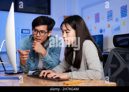 Programmer and developer teamwork working in a software development and coding technologies at night. Stock Photo