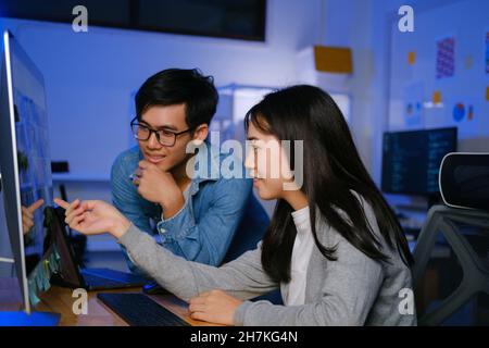 Programmer and developer teamwork working in a software development and coding technologies at night. Stock Photo
