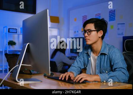 Programmers and developer teams are coding and developing software. Stock Photo