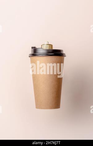christmas bauble decoration made of disposable coffee cup on purple background. Minimal New year concept. Close up Stock Photo