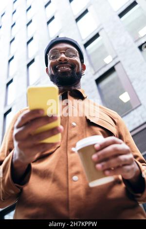 Smiling man using smart phone Stock Photo