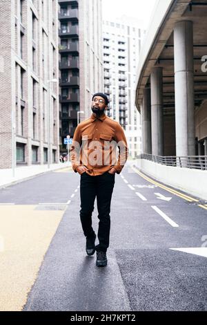 Man walking on road in city Stock Photo