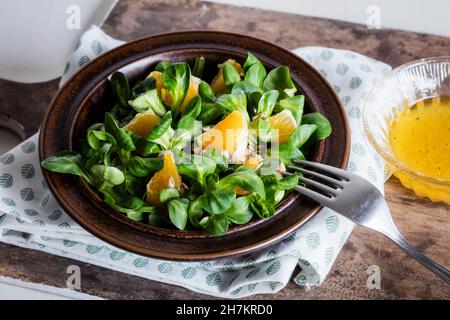 Mid section of woman eating bowl of raw vegan pad thai Stock Photo