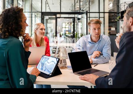 Employees having discussion in office meeting Stock Photo