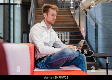 Young businessman using tablet PC at workplace Stock Photo