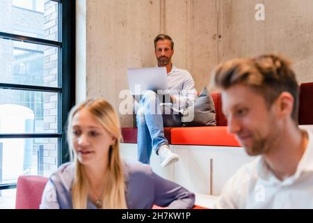 Businessman using laptop in coworking office Stock Photo