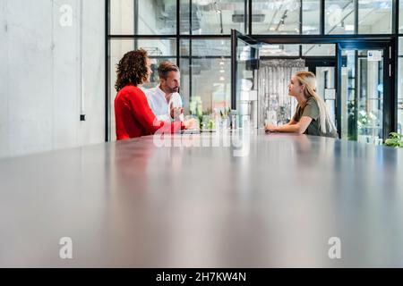 Recruiters having discussion with candidate at conference table Stock Photo